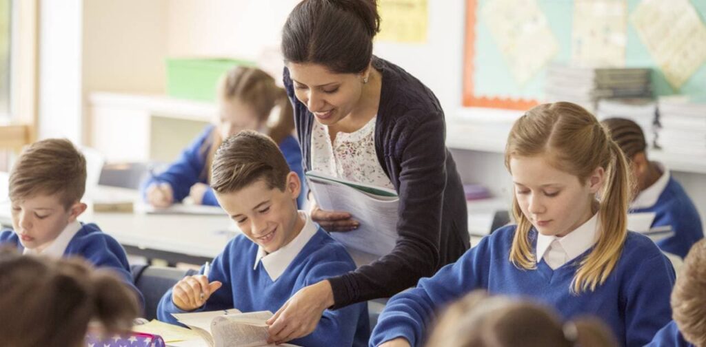 Female teacher with her pupils in classroom