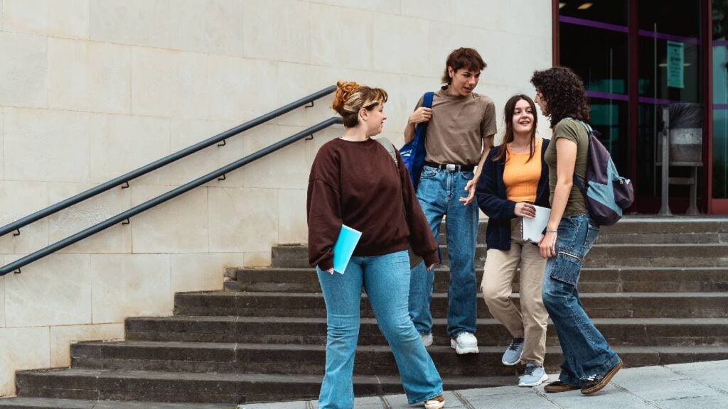 Students walking down a set of stairs after their study session in their college library.